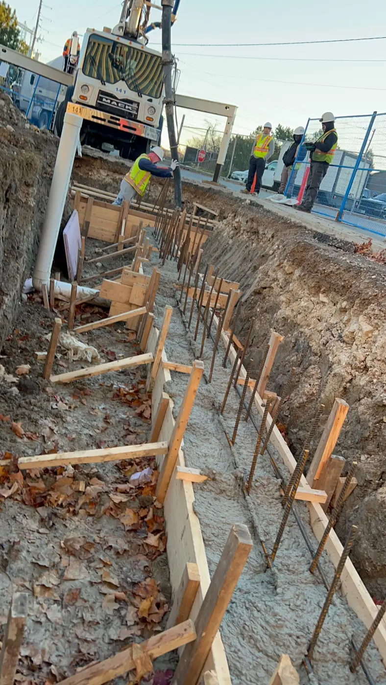 Concrete footing for retaining wall construction