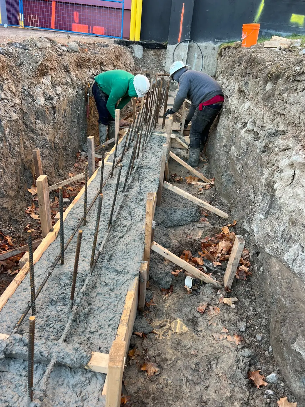 Concrete footing for retaining wall construction